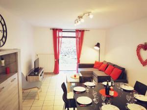 a living room with a table and a couch at Gîte des 3 vallées in Baume-les-Messieurs
