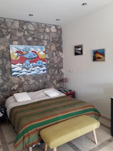a bedroom with a bed and a painting on the wall at Soba Bosa in Opatija