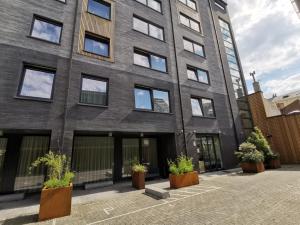 a brick building with potted plants in front of it at Tower Hotel Aalst in Aalst