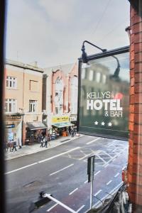 a sign for a hotel on a city street at Kellys Hotel in Dublin