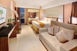 a hotel room with a bed and a couch at Yuan Garden Pasar Baru in Jakarta