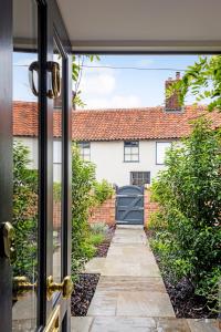 a door view of a house with a driveway at The Sail House in Wighton