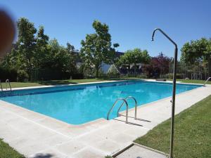 a swimming pool in a yard with a street light at La Casita de la Sierra Cercedilla in Cercedilla