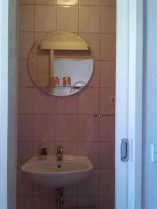 a bathroom with a sink and a mirror at Rooms Katica in Korčula