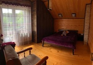a bedroom with a bed with a teddy bear on it at Villa Melaniia in Rozgirche