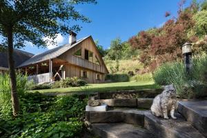 a cat sitting on steps in front of a house at Homestead farm Tešnak in Gorenja Vas