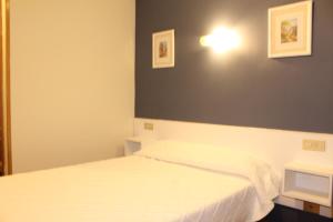 Postel nebo postele na pokoji v ubytování Hotel Fuente La Plata