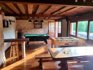 a living room with a pool table and tables at La Fuente del Poval in Caballar