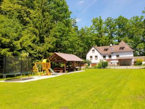 a yard with a playground and a house at Penzion Prátr in Třeboň