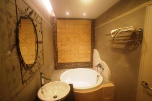 a bathroom with a sink and a toilet and a mirror at Hong Ben Hotel in Kenting +88 photos