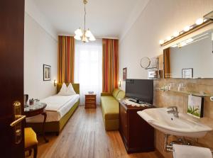 a hotel room with a bed and a sink at Hotel Austria - Wien in Vienna
