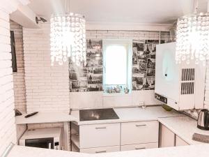 a kitchen with white appliances and white brick walls at Vip Sadyba Svalyava in Svalyava +116 photos