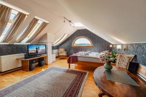 a large living room with a bed and a table at Hotel Klika in České Budějovice