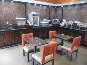 a restaurant with two tables and chairs and a counter at Best Western Emporia Inn in Emporia