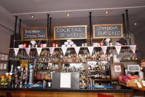 a bar with a lot of bottles of alcohol at Carmelite Hotel; BW Signature Collection in Aberdeen