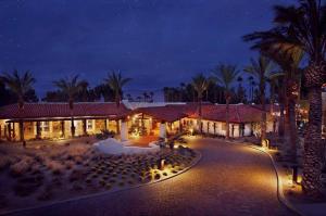 un complejo con palmeras y luces por la noche en La Casa Del Zorro Resort & Spa, en Borrego Springs