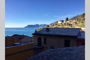 a view of the ocean from the roof of a building at Casa Oliva Cinque Terre in Manarola +19 photos