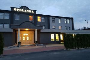 a black building with a sign on top of it at Hotel Opolanka in Opole