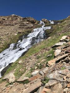 a waterfall on the side of a rocky mountain at Hostal Casa Fermina- A 2 horas de las pistas de esquí in Trevélez