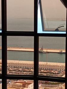 a view of a large building from a window at Al-marsa2 in Al Hoceïma