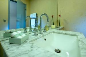 a bathroom with a sink and a large mirror at Hotel Penz West in Innsbruck