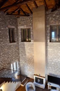 a room with a brick wall with a fireplace at The three houses in Kalamata