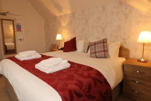 a hotel room with a bed and two lamps at County Hotel in Kendal