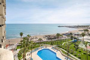 a view of the beach from the balcony of a resort at Sol Puerto Marina in Torremolinos