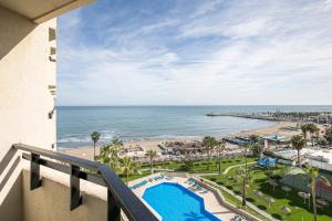 a view of the beach from a balcony of a resort at Sol Puerto Marina in Torremolinos