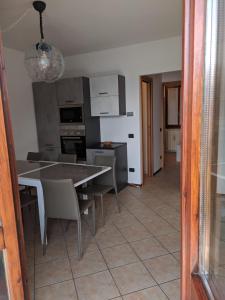 a kitchen and dining room with a table and chairs at SWEET VIEW in Varenna