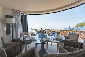 a dining room with a table and chairs at The Beach House at Sandgate by Bloom Stays in Sandgate