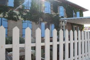 a white picket fence in front of a house at Les saladelles in Salin-de-Giraud