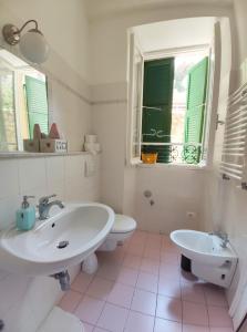 a bathroom with a sink and a toilet and a window at Chez Tamara with private parking and air conditioned in Monterosso al Mare