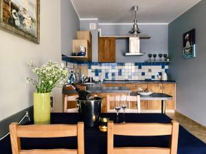 kuchnia ze stołem z 2 krzesłami i jadalnią w obiekcie Apartament Regata w sercu Mariny w Ustce w Ustce