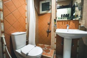 a bathroom with a toilet and a sink at Platinum Seventy in Jeddah