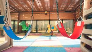 a group of swings in a playground at Platinum Seventy in Jeddah