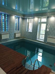a large swimming pool with at Дом у моря с бассейном и сауной in Odesa