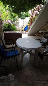 a white table and chairs on a patio with stairs at GORAN'S PLACE in Hvar