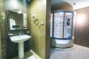 a bathroom with a sink and a shower and a toilet at Platinum Seventy in Jeddah