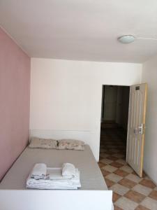 a room with a bed in a room with a door at Пай Хост in Plovdiv