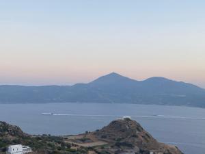 a view of a large body of water with a mountain at Studios Betty in Plaka Milou