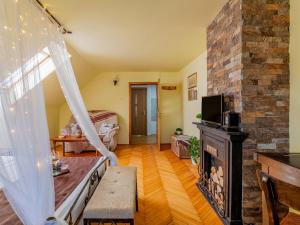 a living room with a fireplace and a stone wall at Lavanda Apartment in Sighişoara