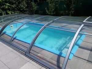 a swimming pool with a glass roof at Chalupa na Hrbku in Svit