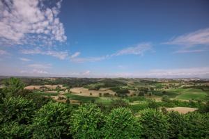 uma vista para um campo com árvores e um céu azul em Il Pozzo Fiorito em Cossombrato