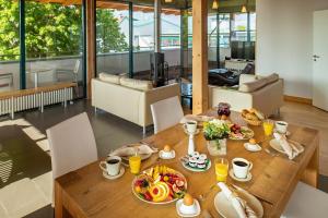 a dining room with a table with food on it at Recknitztal-Hotel Marlow in Marlow