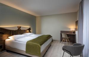 Postel nebo postele na pokoji v ubytování Tryp by Wyndham Rosenheim + 37 fotografií