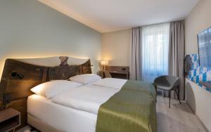 Postel nebo postele na pokoji v ubytování Tryp by Wyndham Rosenheim