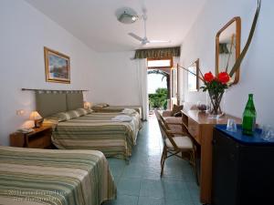 Postel nebo postele na pokoji v ubytování Hotel Calabattaglia