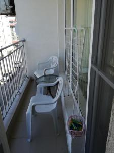 a balcony with two chairs and a table at Krasi Apartments in Perla Complex in Pomorie