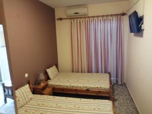 Postel nebo postele na pokoji v ubytování Ο Ακλόνητος